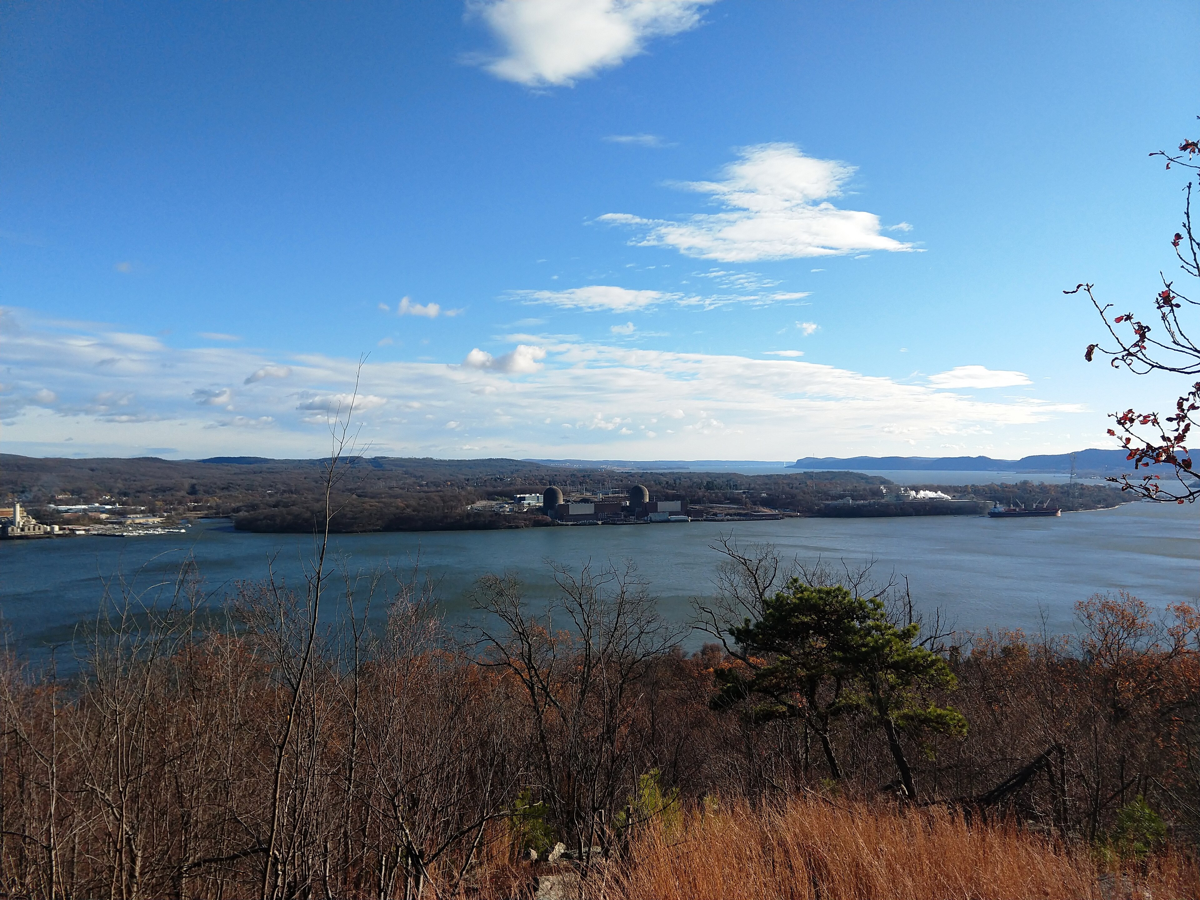 Indian Point Unit 2 — The Indian Point Energy Center seen from Dunderberg Mountain in 2024 — a plant-wide view. Nothing here is identified as Unit 2 or as Kelly's work area.