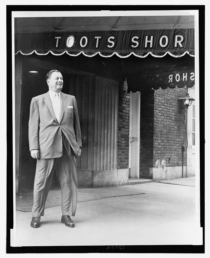 Toots Shor standing outside his new restaurant, photographed for the World Telegram & Sun. The doorway and canopy of the second location, the site on Rita's list.