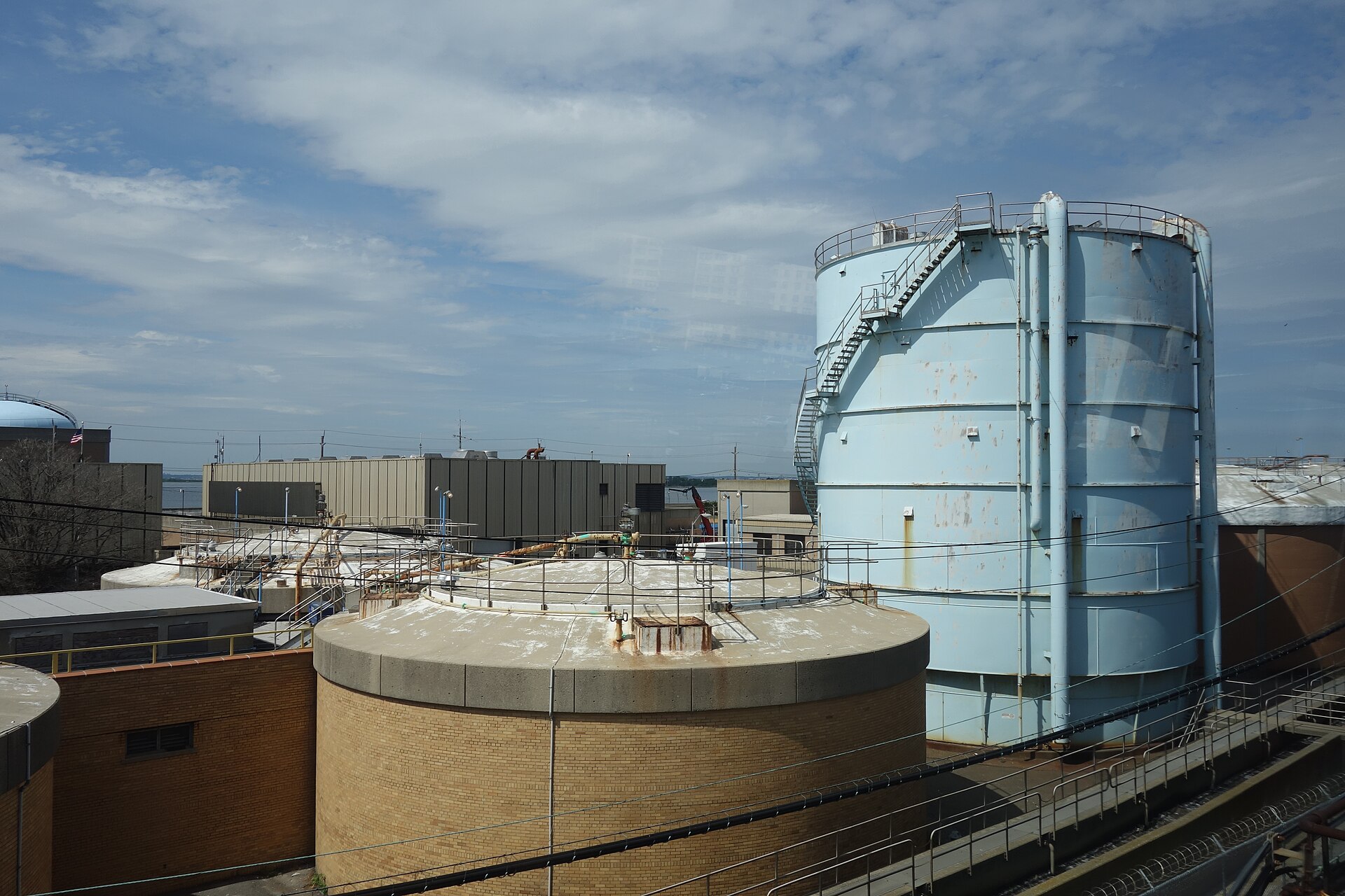 Rockaway Wastewater Resource Recovery Facility — Looking north at the Rockaway Wastewater Treatment Plant, at the Rockaway Freeway and Beach 108th Street in Seaside / Rockaway Park, Queens. Looking from a Rockaway Park–Beach 116th Street-bound…. Photographed in 2018; a current view, not a construction-period photograph.